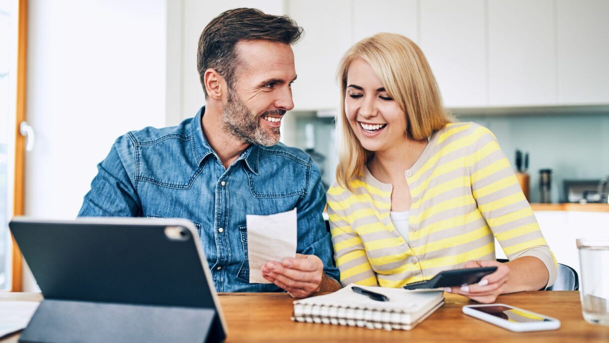 A happy couple reviewing their approved insurance claim paperwork, relieved after Empire Contractors LLC successfully handled their roof repair process. Empire Contractors LLC provides expert roofing services and insurance claim assistance in Cincinnati, OH, and surrounding areas.