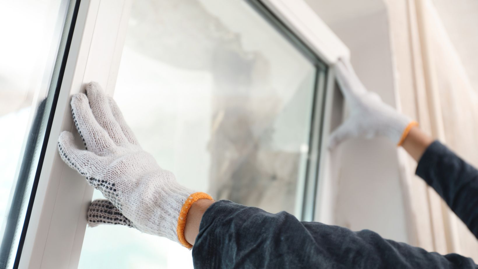 Professional contractor installing new glass in a residential window for improved energy efficiency and insulation. Empire Contractors LLC offers expert window repair and replacement services in Cincinnati, OH, and surrounding areas.
