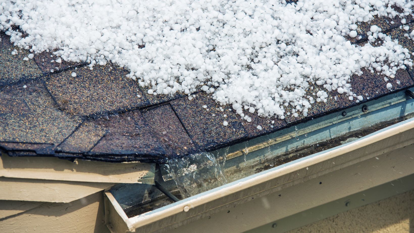 A residential roof covered in snow with visible damage, including ice dams and potential leaks. Empire Contractors LLC provides expert roof repair and winter damage restoration services in Cincinnati, OH, and surrounding areas.
