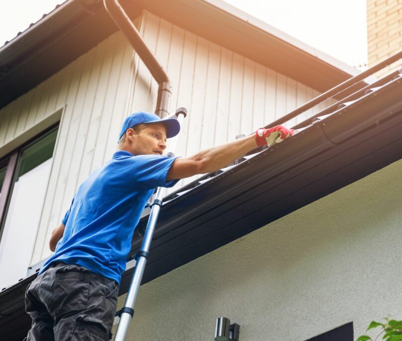 Empire Contractors LLC team member inspecting a residential roof for damage and leaks. Expert roofing services, including repairs and replacements, available in Cincinnati, OH, and surrounding areas.