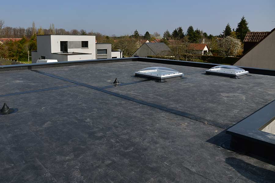 Flat roof with EPDM rubber roofing and skylights, providing durable, waterproof protection for residential and commercial buildings. Empire Contractors specializes in professional EPDM roof installation and maintenance for long-lasting performance.